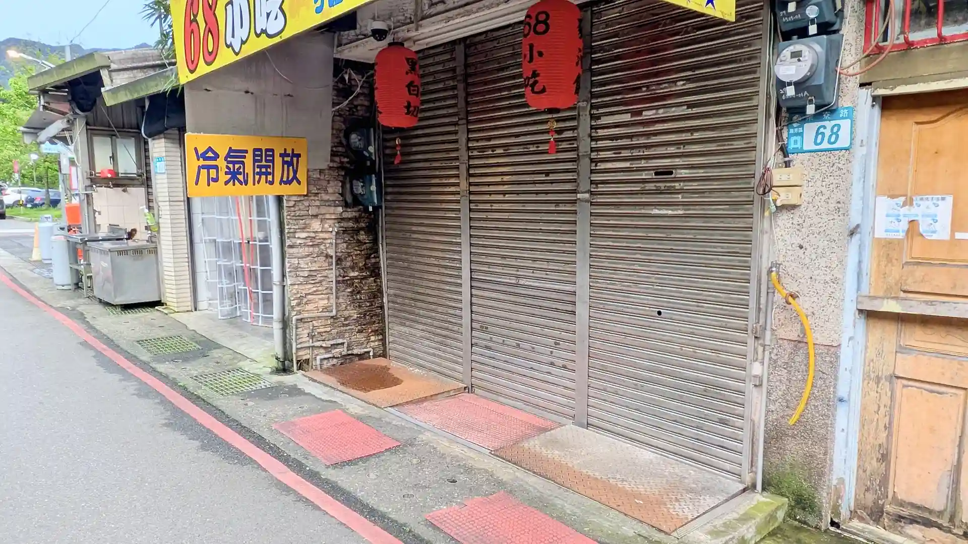 Metal shutters closed across the front of a business in Houtong, Taiwan.
