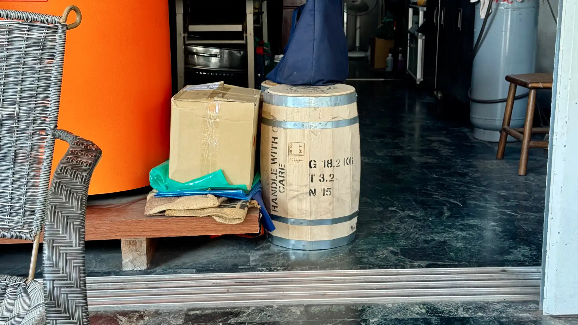 Two closed wooden barrels of coffee at the entrance of Hou Yun Coffee Roastery.
