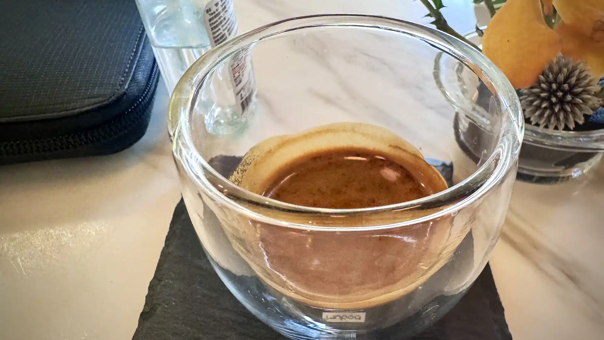 Close-up of a single shot espresso in a glass demitasse.