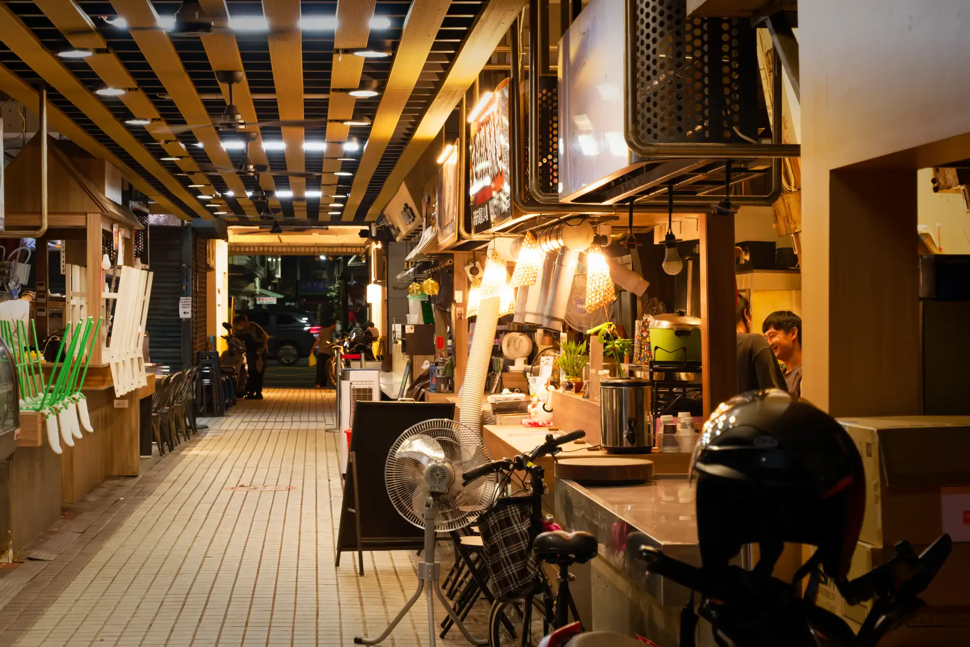 People smiling behind the counter at a take-out eatery in Kaohsiung, Taiwan.