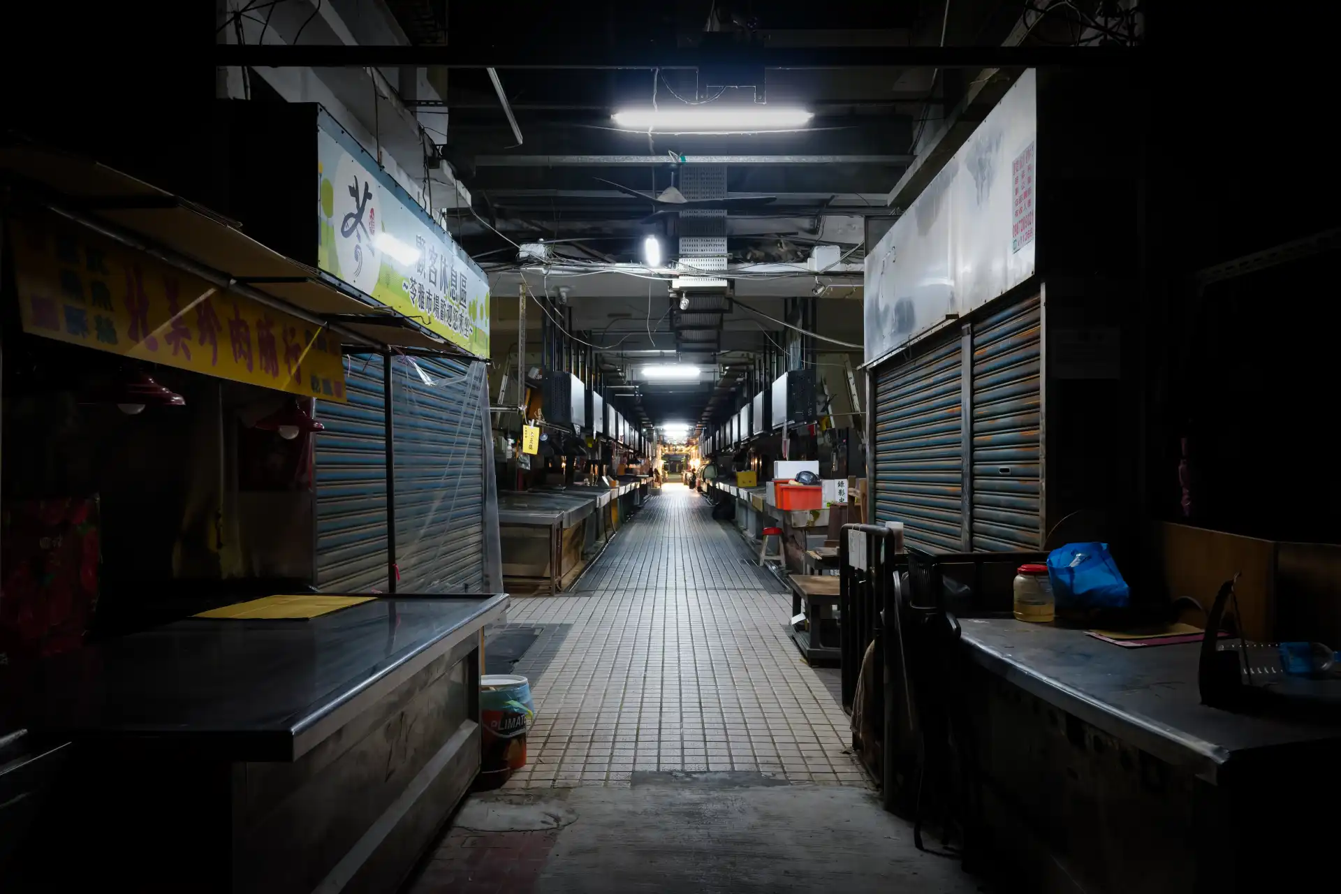 A deserted wet market at night.