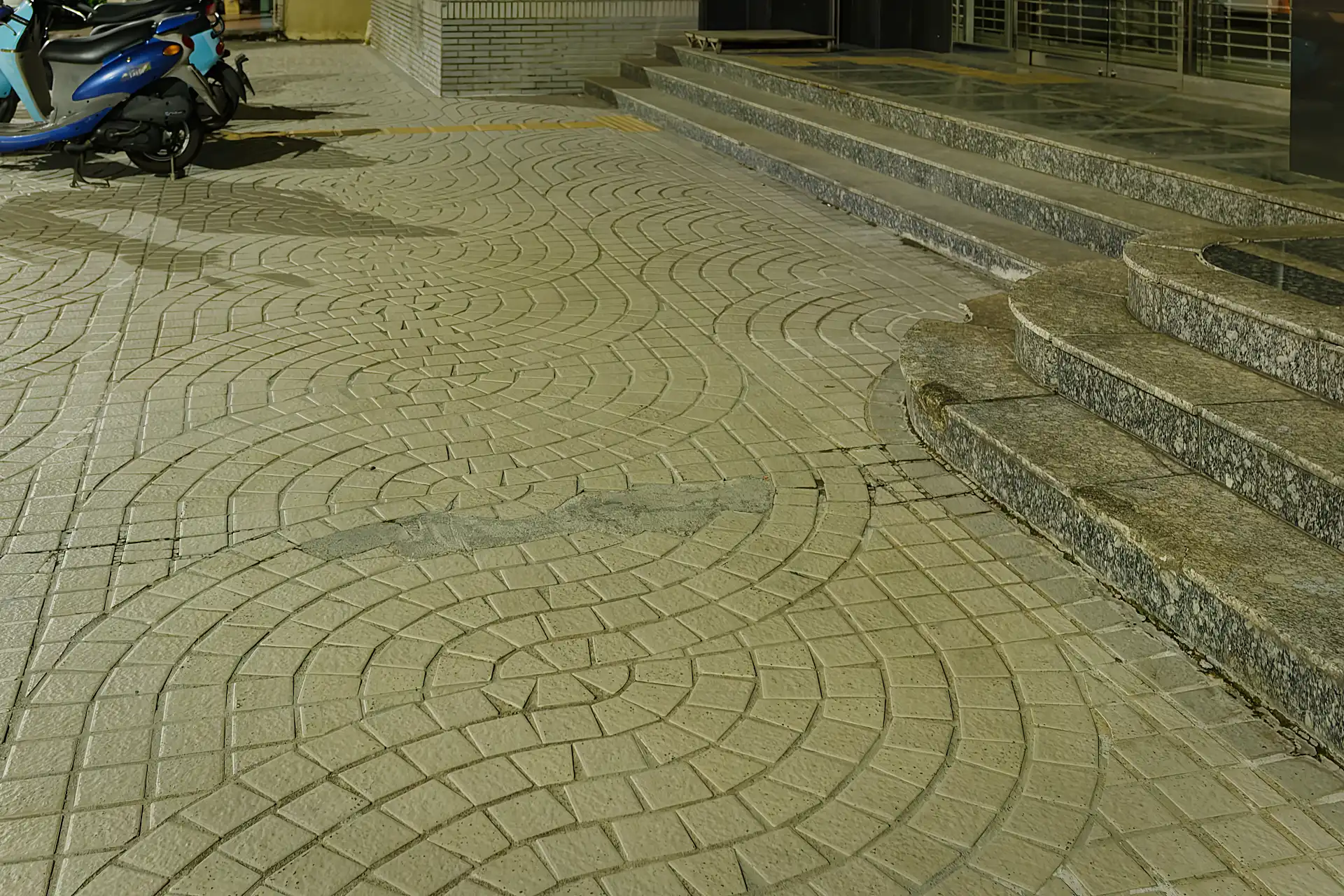 Wavy paving on a sidewalk outside a Union Bank of Taiwan branch.