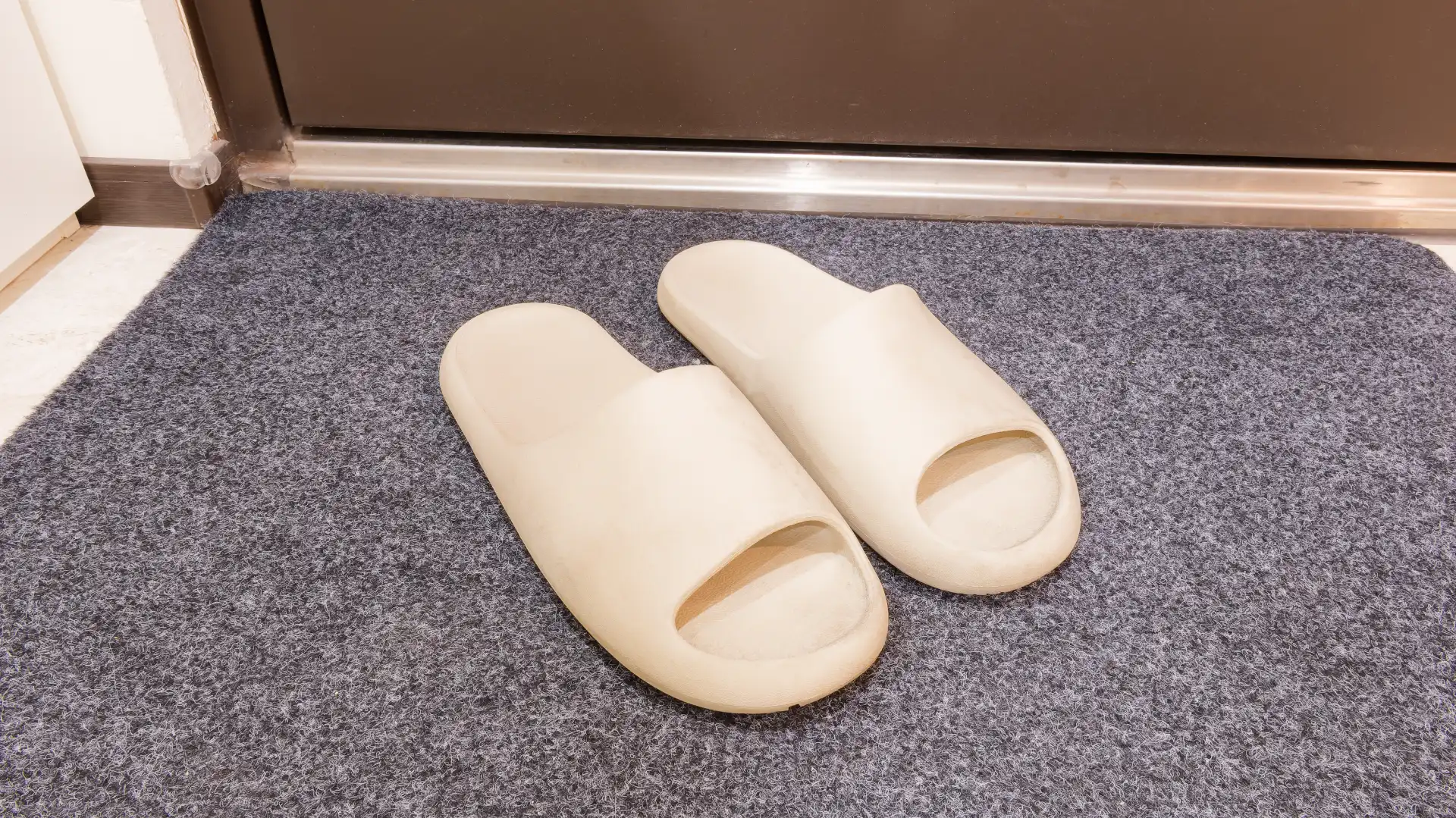 A pair of cream rubber Decathlon-branded slides in Taiwan.