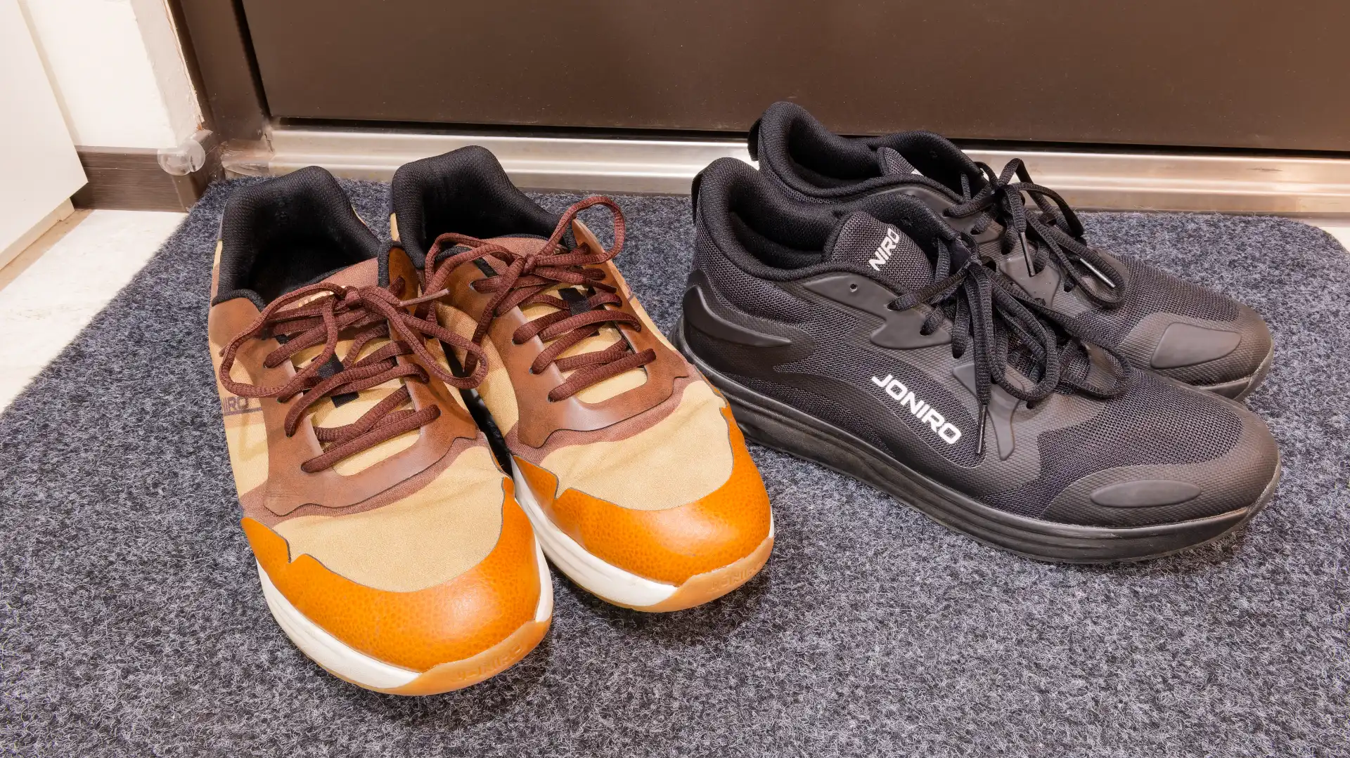 Two pairs of size 13 Joniro sneakers in Taiwan, one black and one tan.