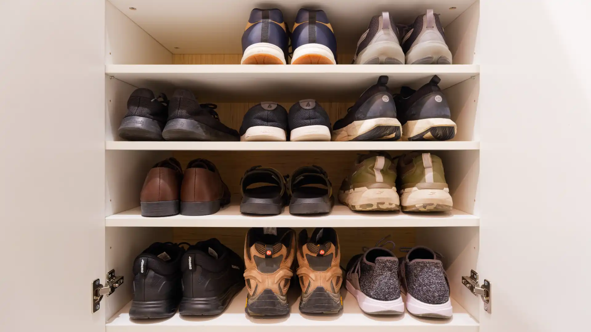 A four-shelf shoe cabinet in a Taiwanese apartment, with various types of shoes occupying 11 of 12 spaces.