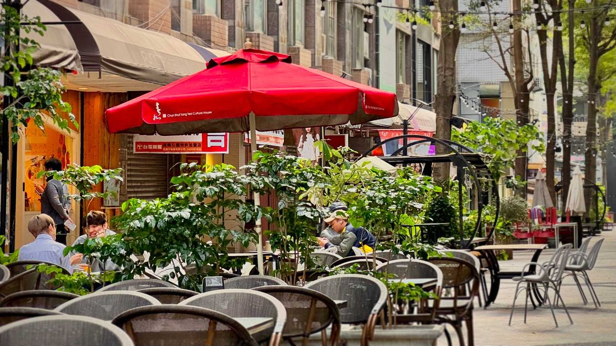 People drinking tea and chatting outside Chun Shiu Tang tea house in Taichung, Taiwan.