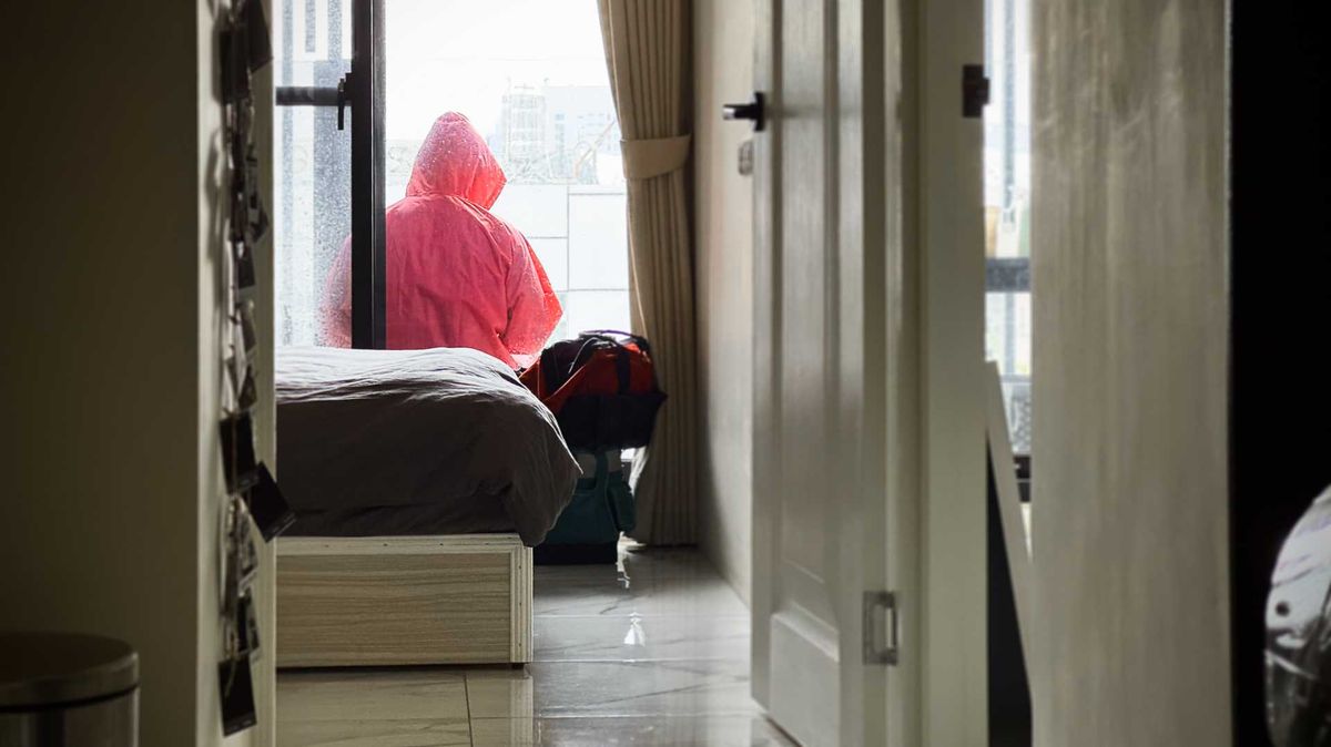 A man in a Squid Game-like red jumpsuit on a balcony in Taiwan.