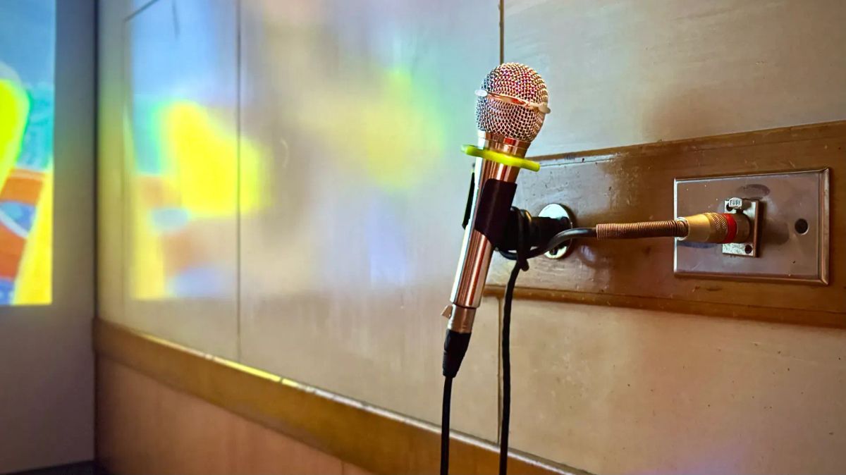 A microphone resting on a wall mount, in a KTV room in Taiwan.