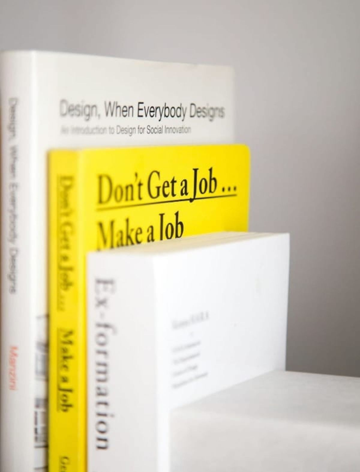 Three motivational books on a shelf.