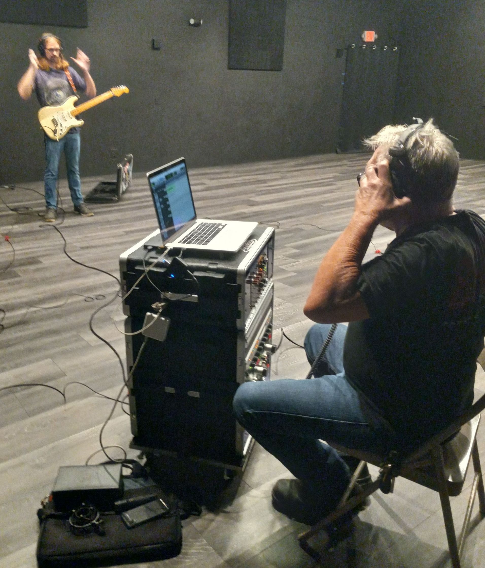 Jesse Bumann giving hand signals to Bob during a recording session