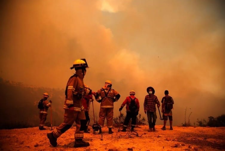Bomberos y vecinos trabajando para apagar los incendios.