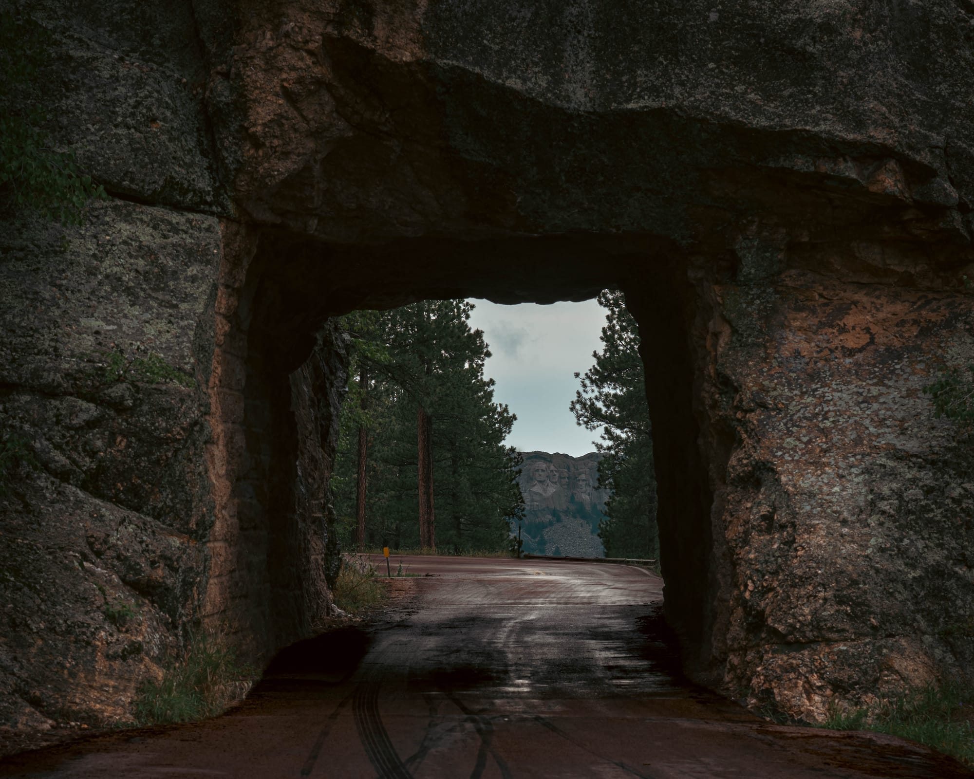 Mount Rushmore framed through Scovel Johnson Tunnel on Iron Mountain Road in the Black Hills.
