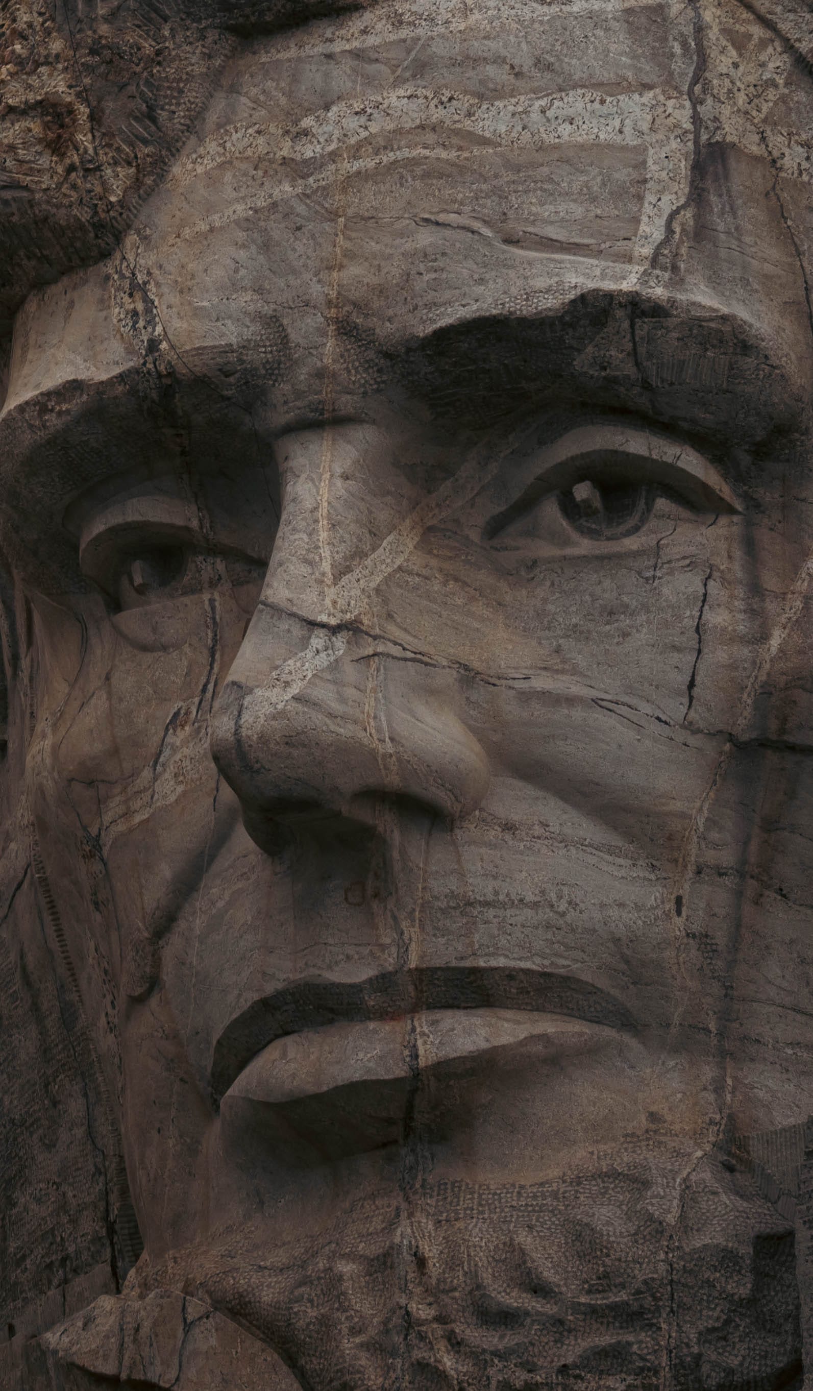 Close portrait of Lincoln's carved granite face at Mount Rushmore.
