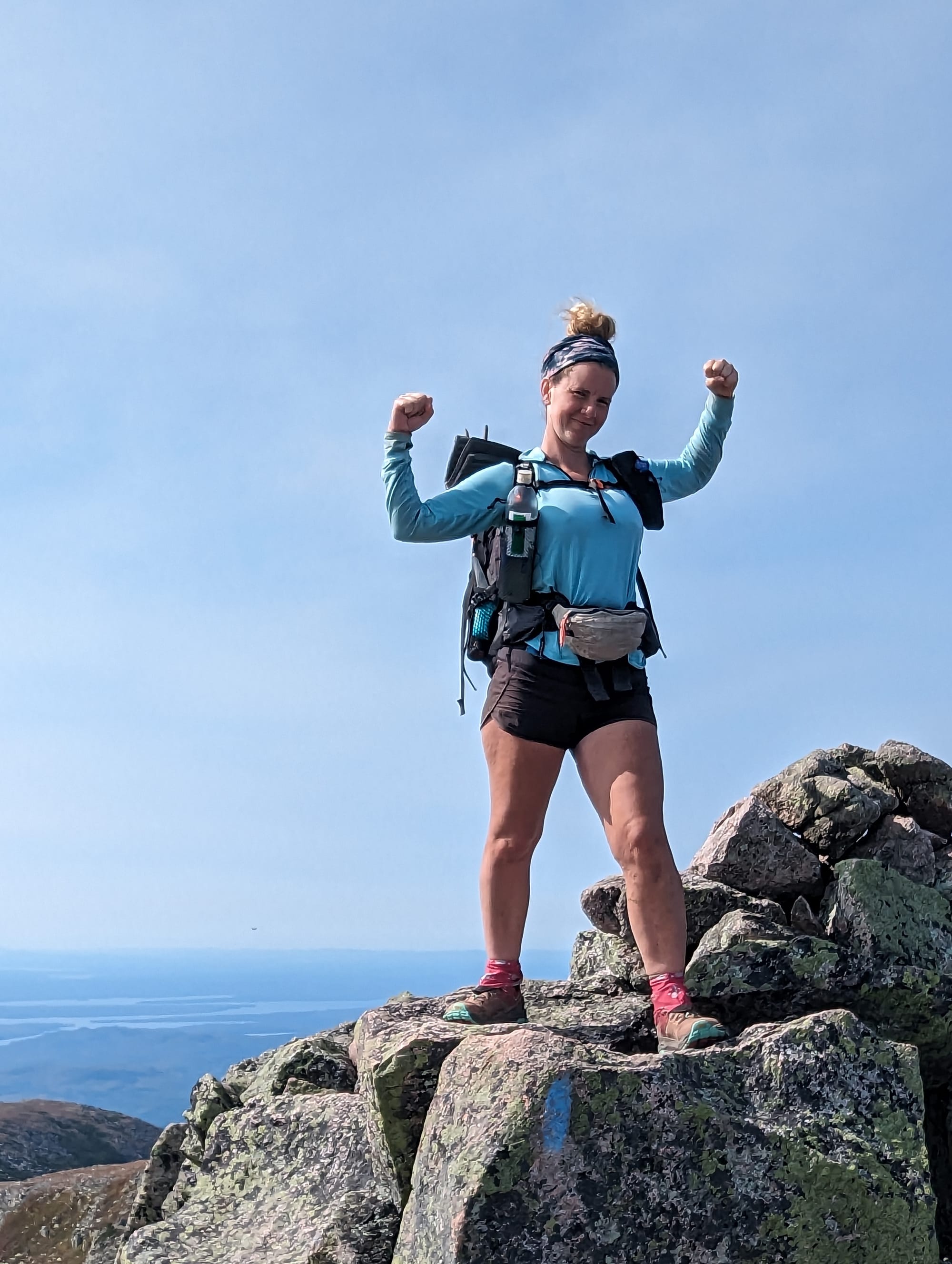 Sunshine celebrating on a granite outcrop during the climb of Mount Katahdin.