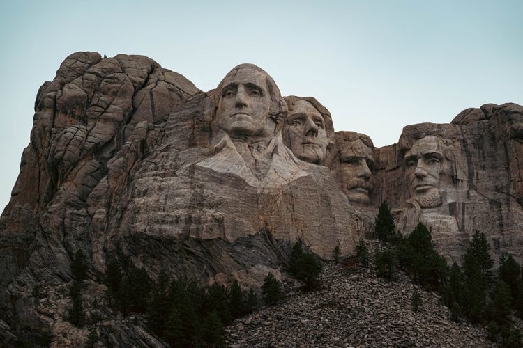 George Washington, Thomas Jefferson, Theodore Roosevelt, and Abraham Lincoln carved into the granite face of Mount Rushmore in South Dakota.