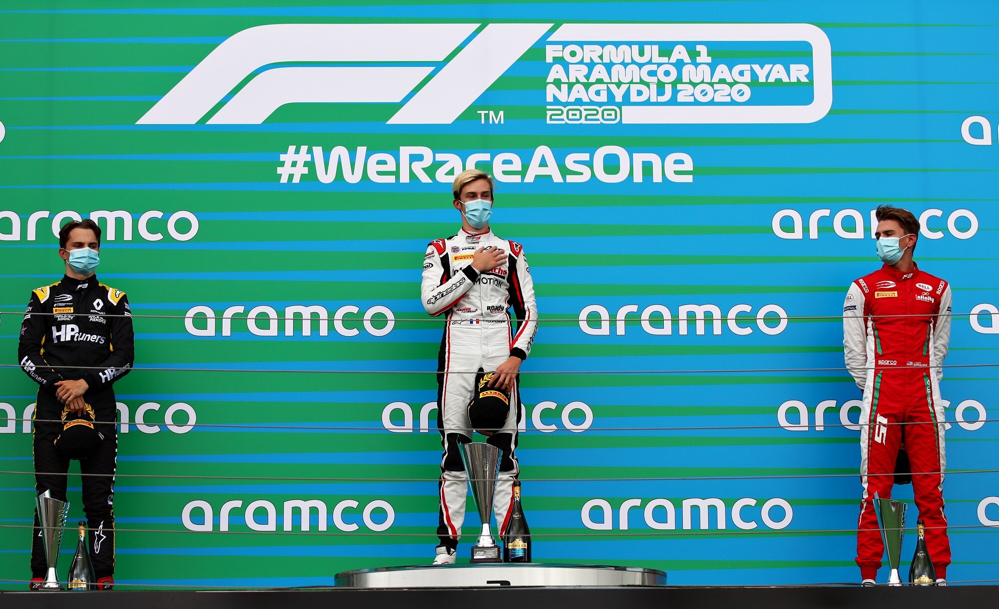 Piastri, Pourchaire, and Sargeant stand on the Hungarian Grand Prix podium