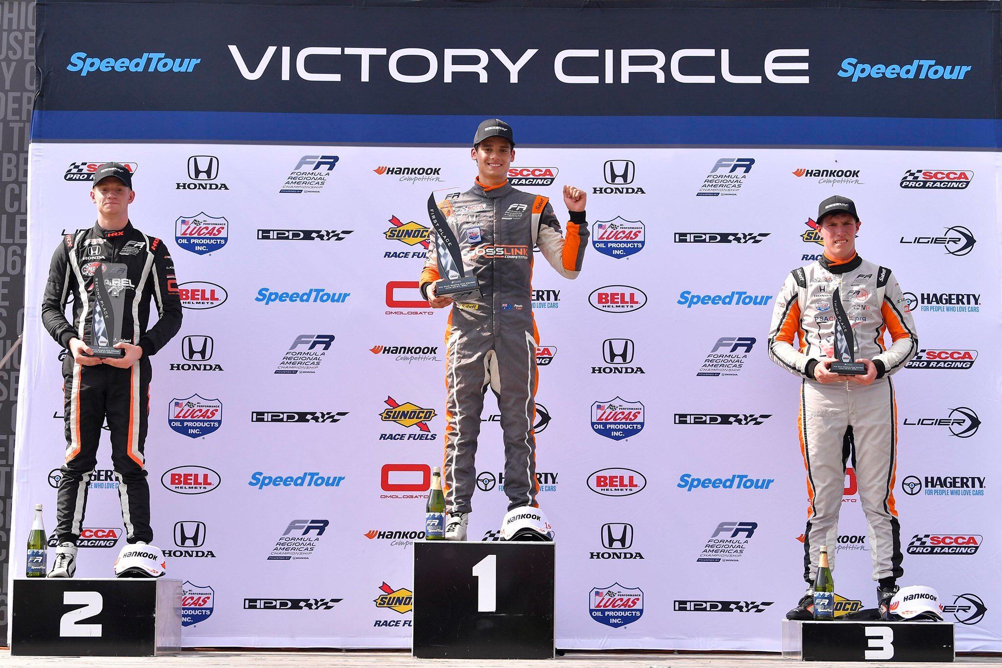 Jacob Car celebrates on the podium with Jacob Abel and Jordan Missig. (FR Americas)
