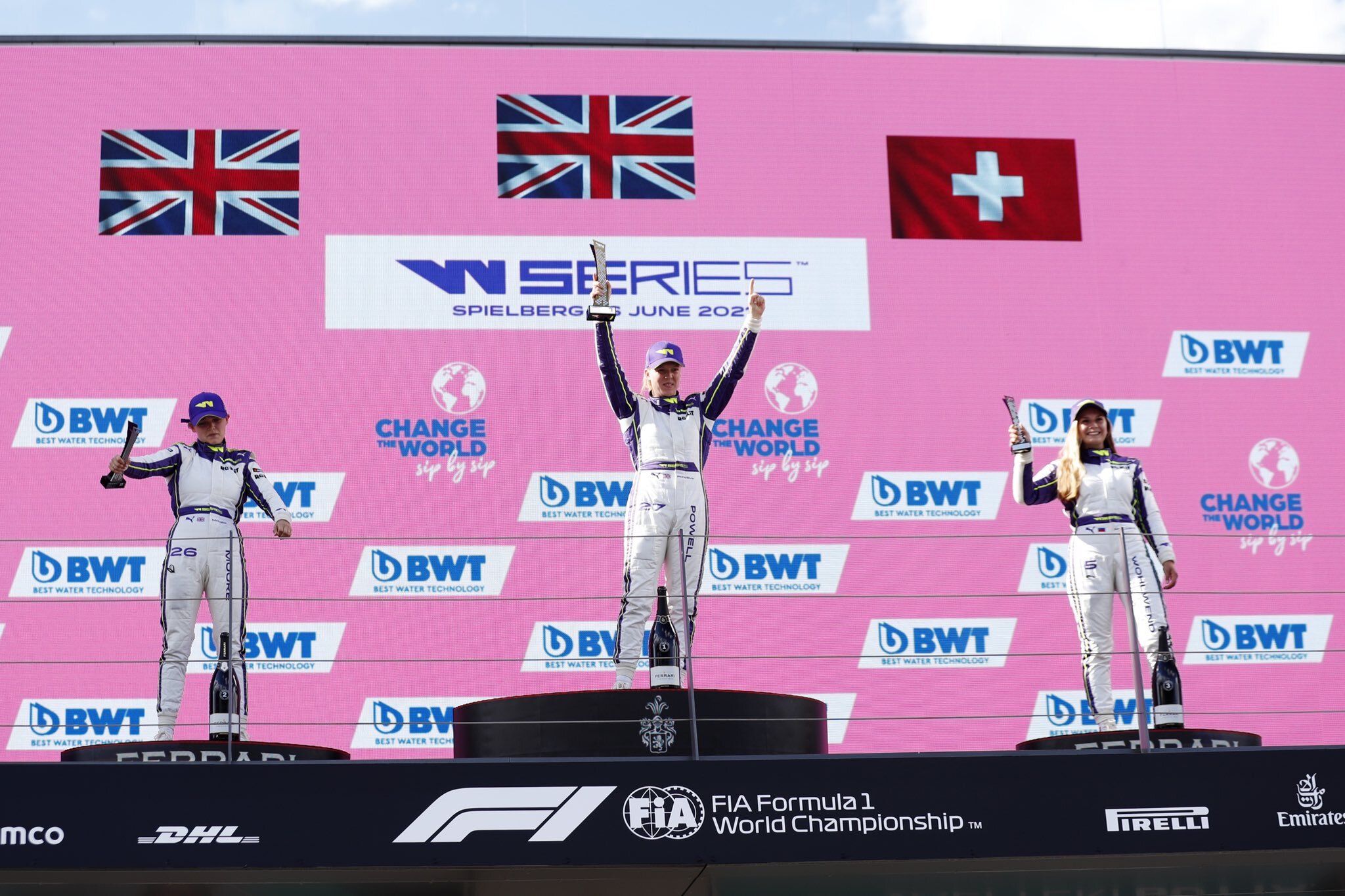 Alice Powell, Sarah Moore, and Fabienne Wohlwend celebrate on the podium in Austria. (W Series)