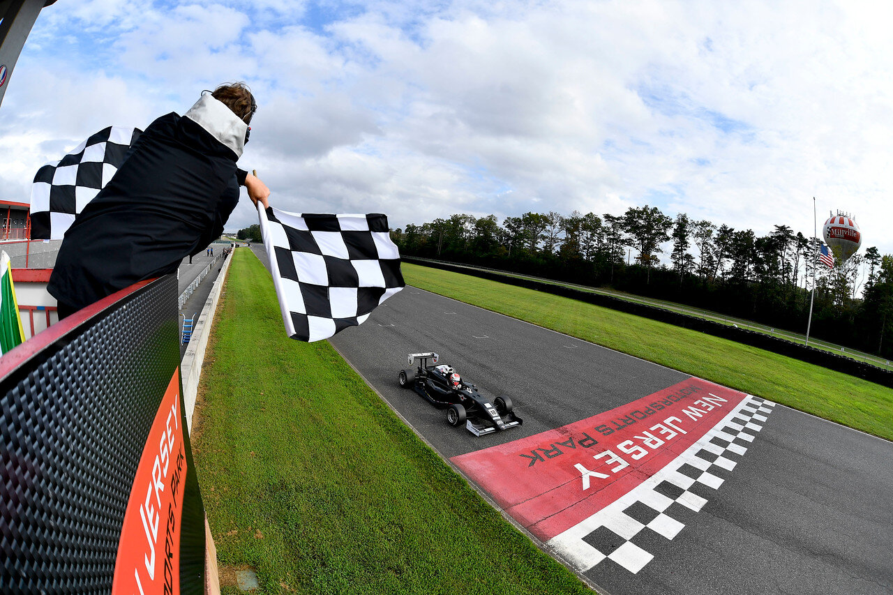 Hunter McElrea takes the chequered flag at New Jersey. (Gavin Baker Photography/Road to Indy)