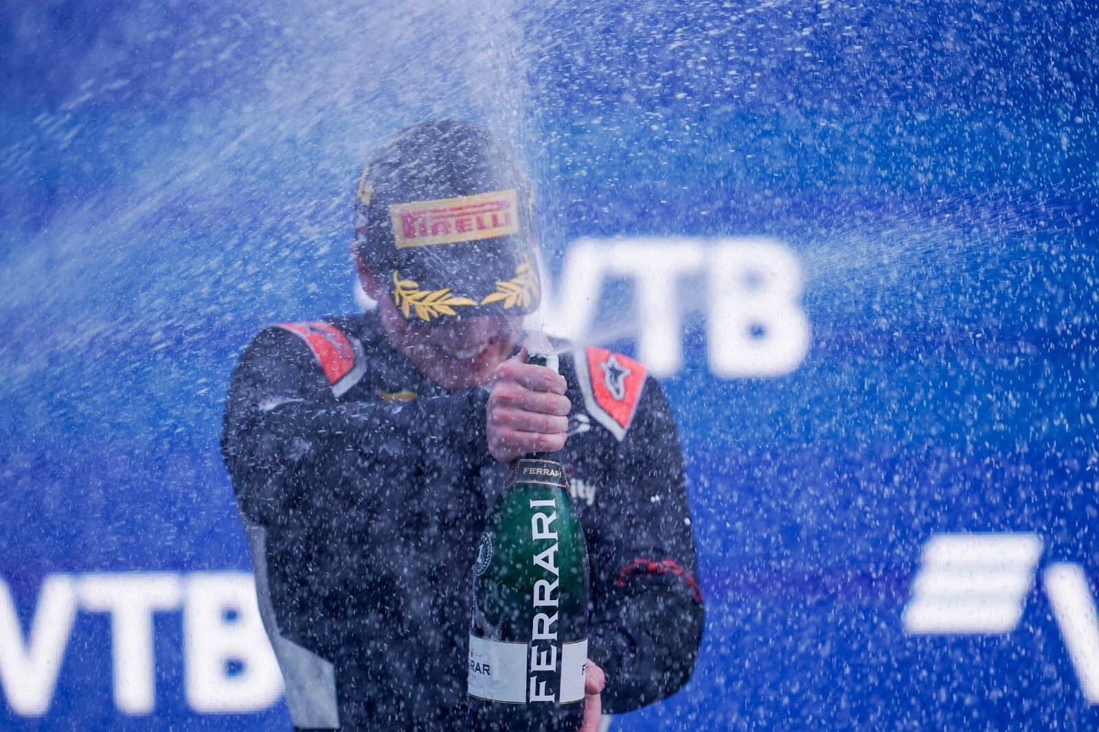 Dan Ticktum celebrates his race victory on the FIA Formula 2 podium at Sochi. (CarlinRacing/Twitter)
