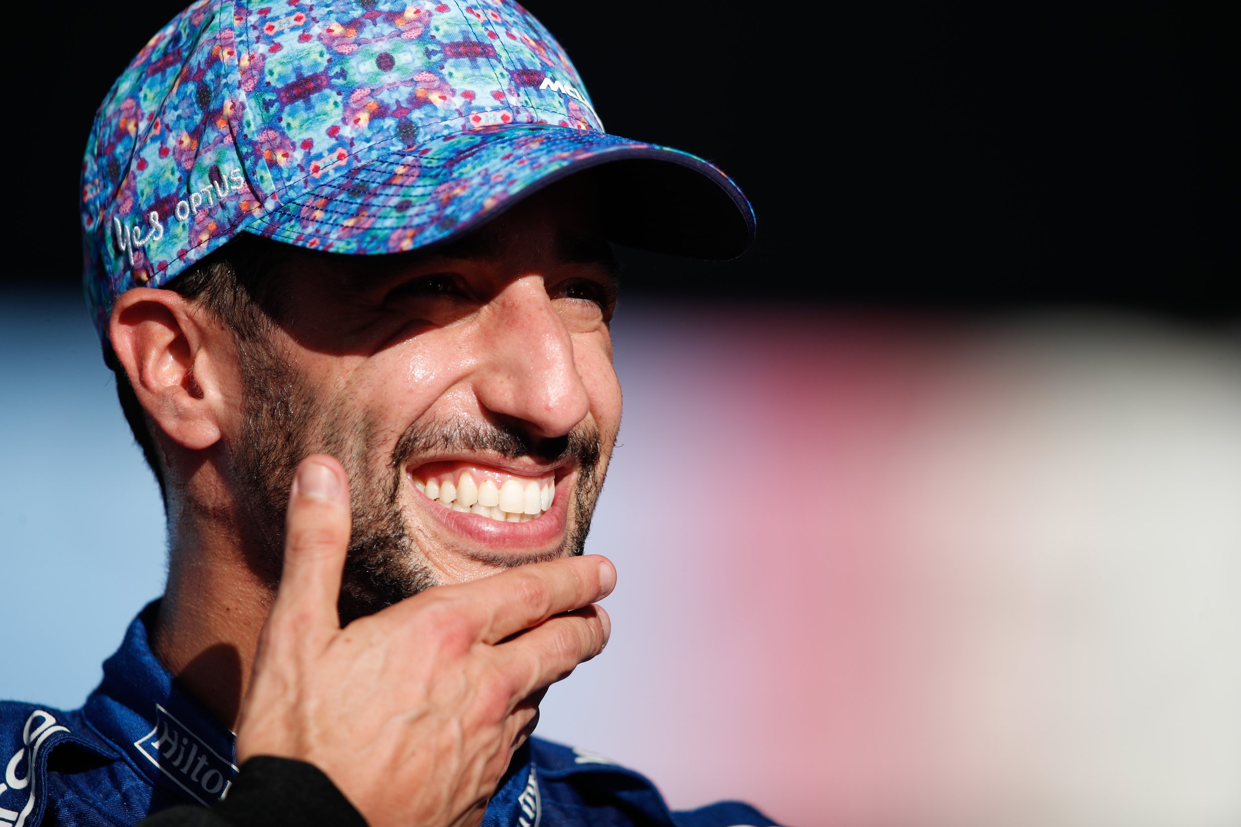 Daniel Ricciardo smiling with his hand on his chin at the United States Grand Prix