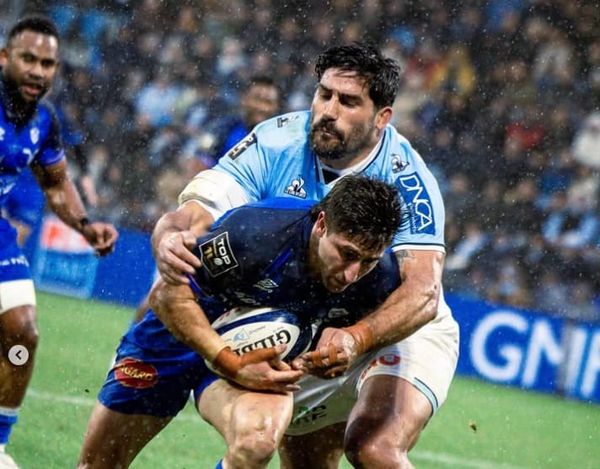 Castres' Santiago Arata is tackled