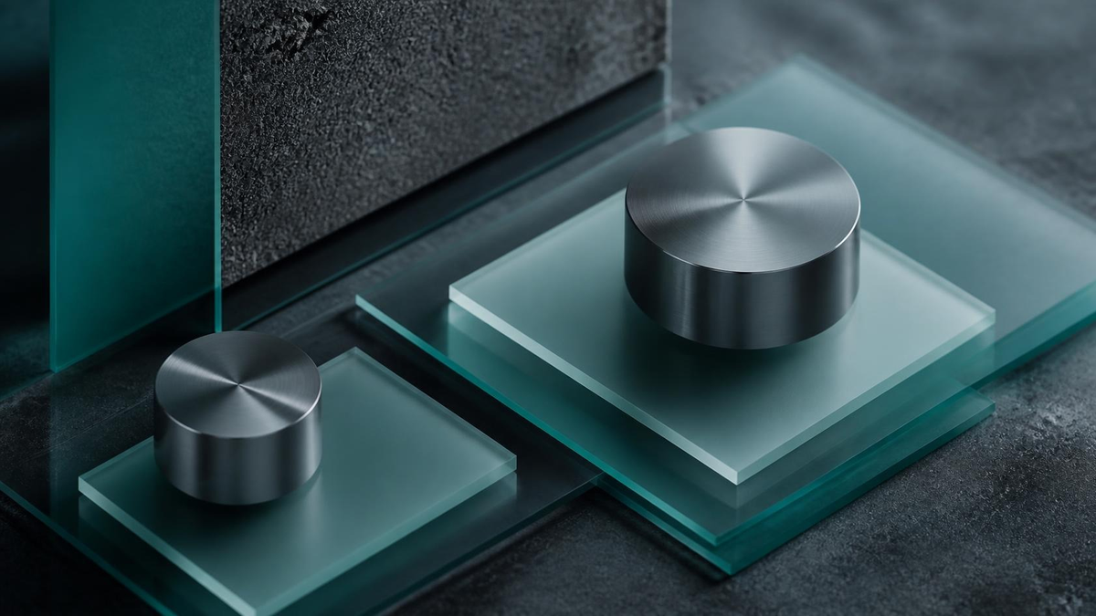 Brushed metal cylinders on layered teal glass slabs. Hire Platform Engineers
