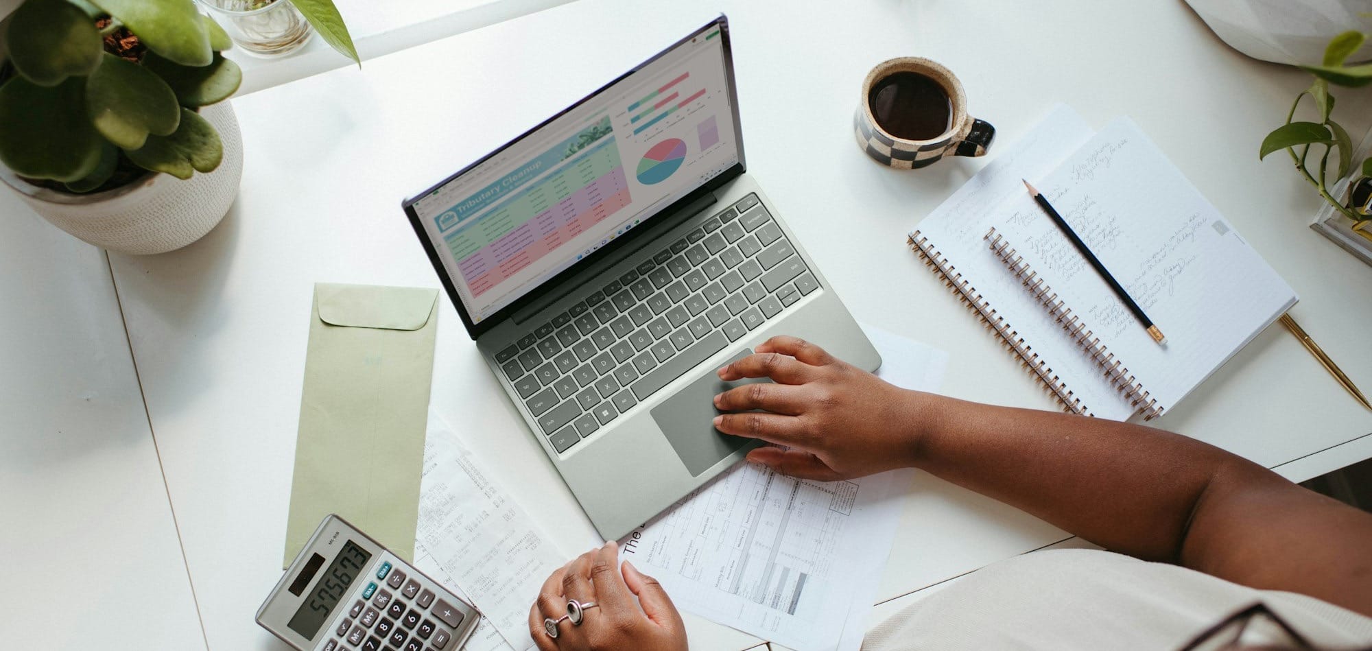 a person sitting at a table with a laptop