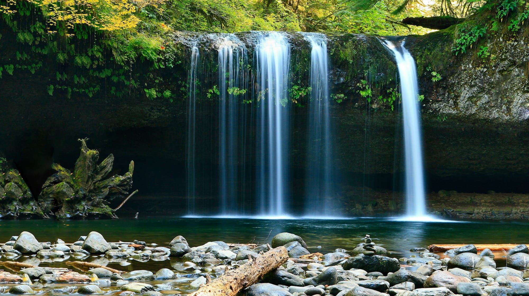 long-exposure photo of lake with waterfall at daytime