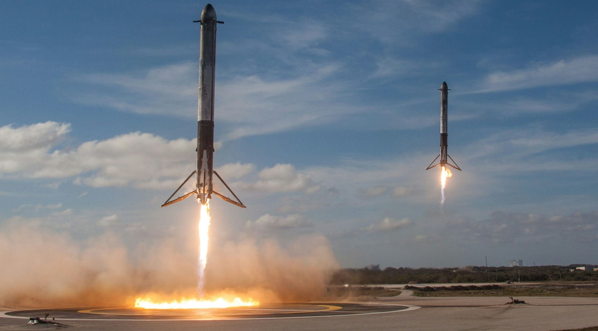 twom white flying rockets during daytime