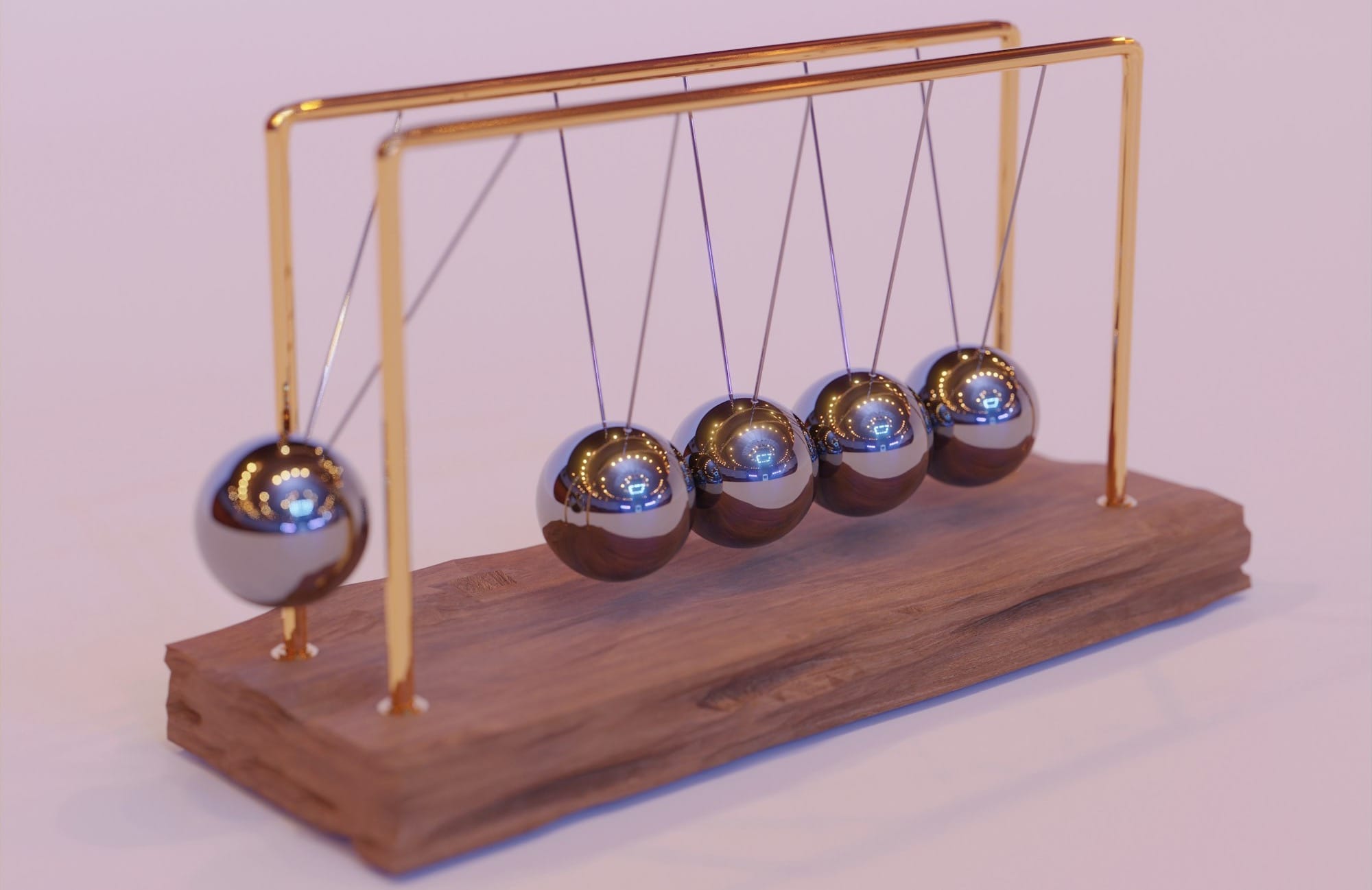 a wooden stand with three metal balls on it
