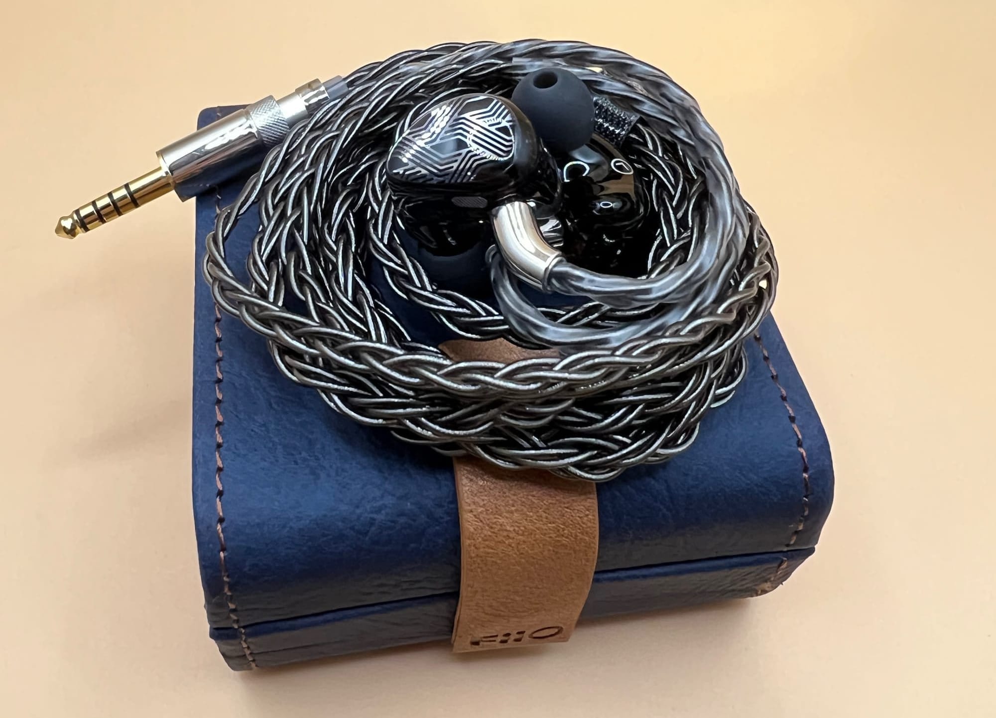 FiiO FA19 sitting on top of leather carrying case