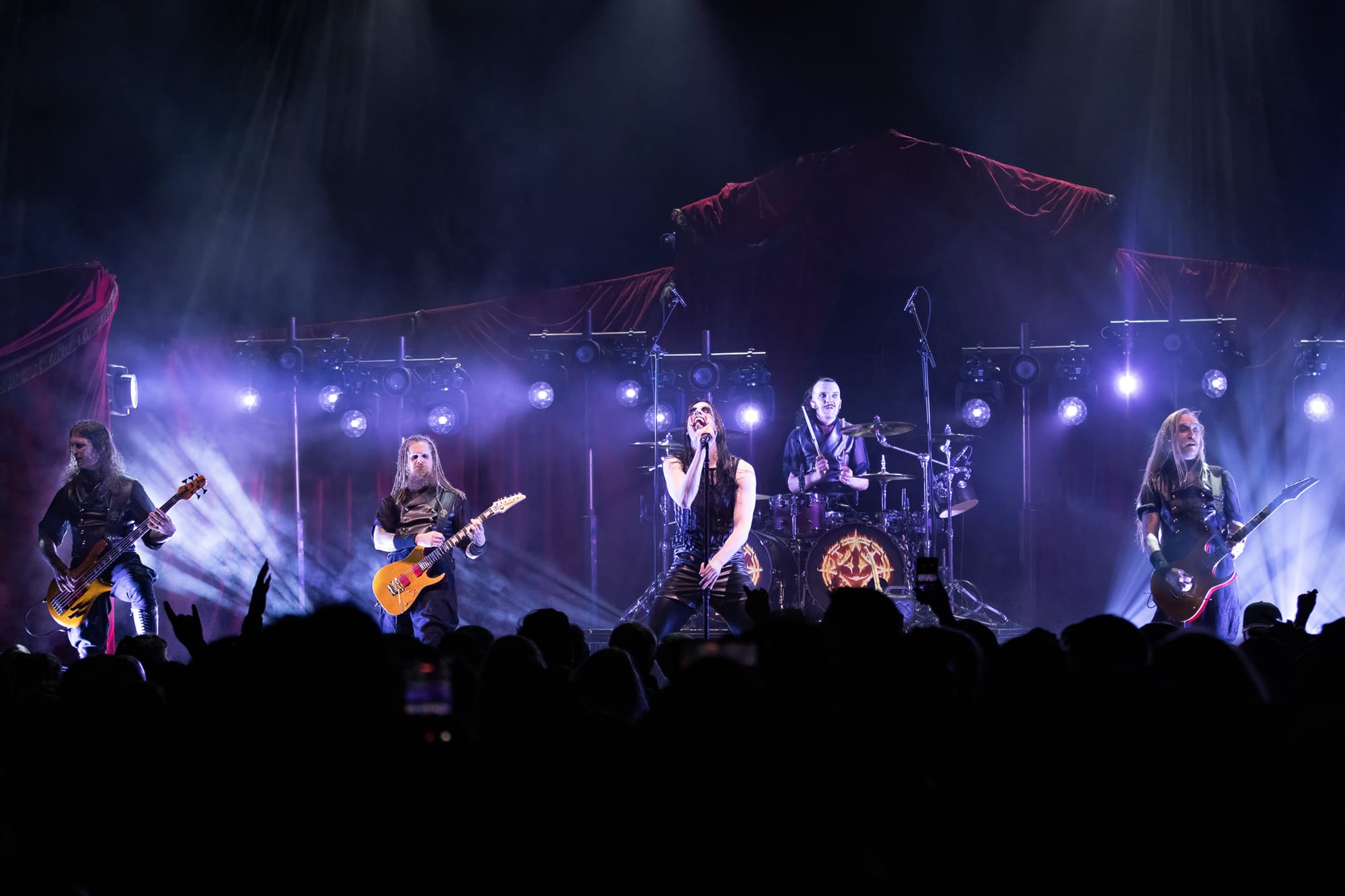 Avatar performing on stage with purple lighting