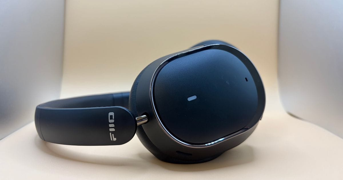 Fiio EH13 Headphone laying down sideways on a tan background