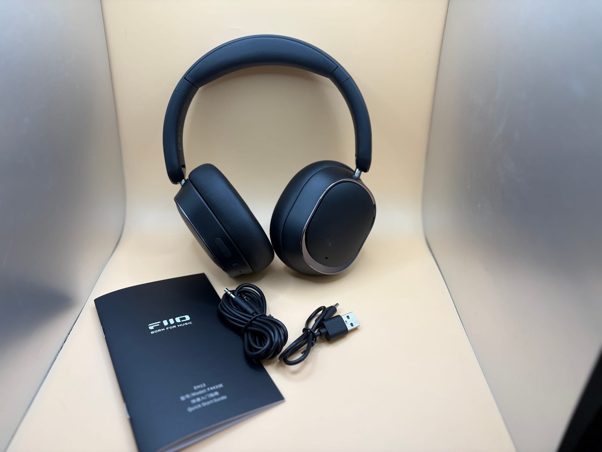 Fiio EH13 Headphone sitting next to 2 cables and handbook