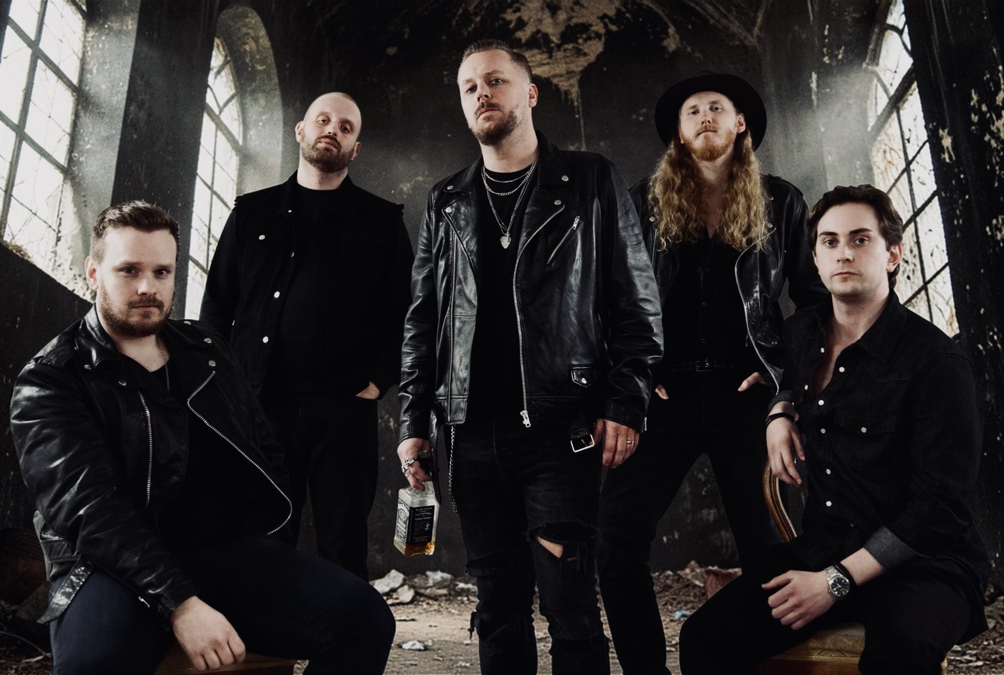 Blessed Insanity Band Photo- 4 members standing in a dark, dramatic abandoned church room