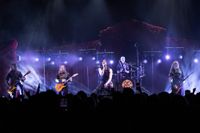 Avatar performing on stage with purple lighting