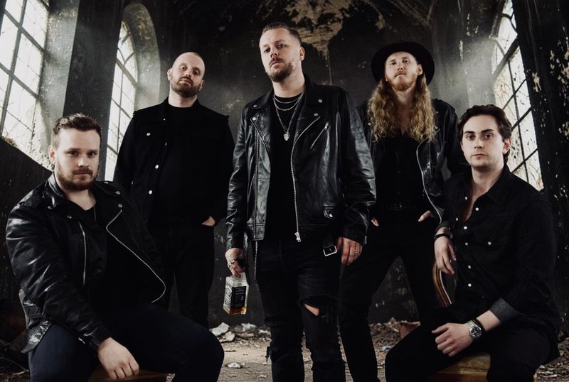 Blessed Insanity Band Photo- 4 members standing in a dark, dramatic abandoned church room