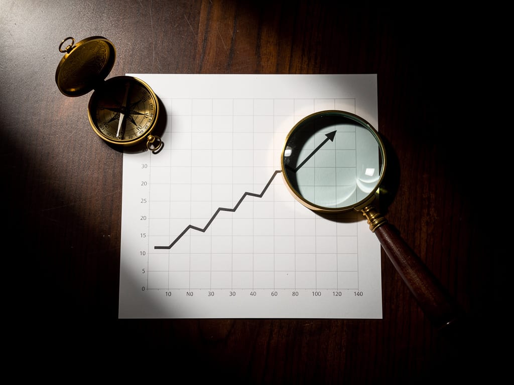 Financial chart with a golden compass symbolizing smart investing.
