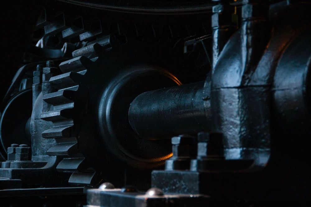 The metal gears and cogs of a large machine.