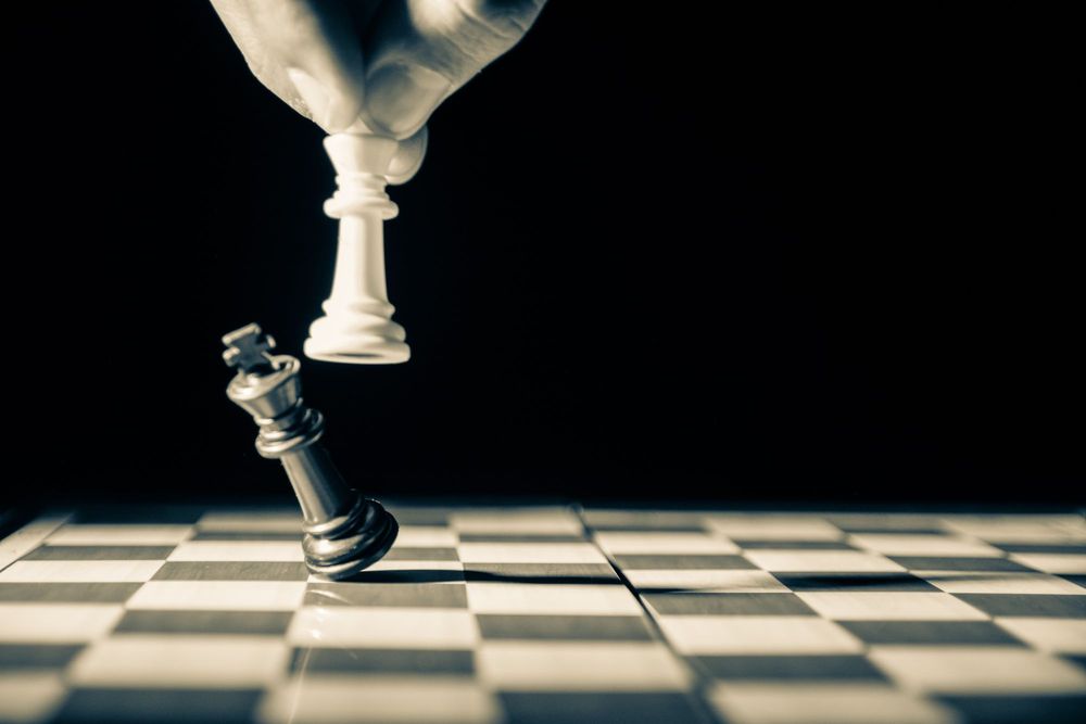A queen knocks over the king in chess.