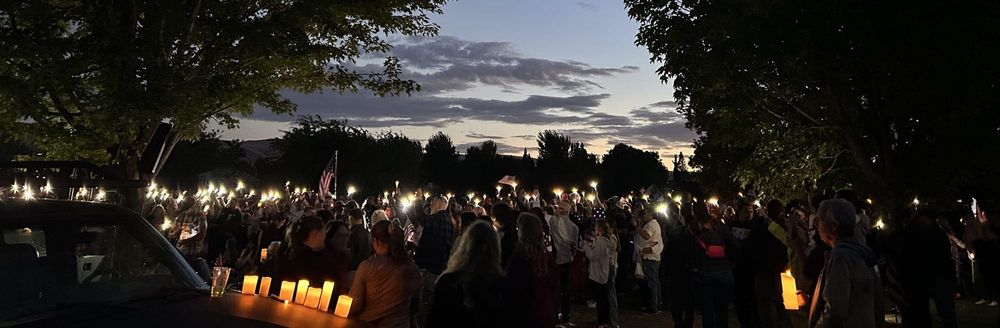 A couple thousand people gathered with lights in a park in vigil for Charlie Kirk.