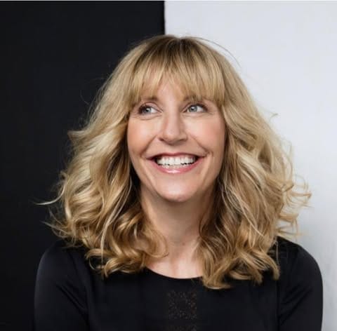 Headshot of author Heidi Amsinck, smiling.
