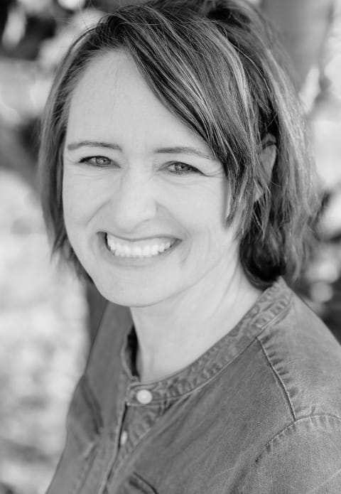 Black and white photograph of Stacey Murray smiling at camera