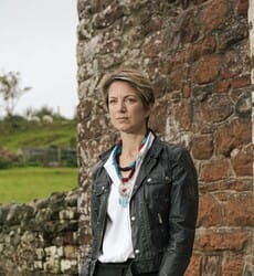 Author Sharon Gosling standing in front of a brick wall