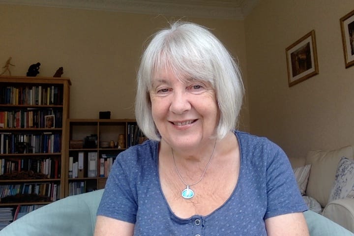 Author Maureen Myant. Smiling at camera in blue shirt.