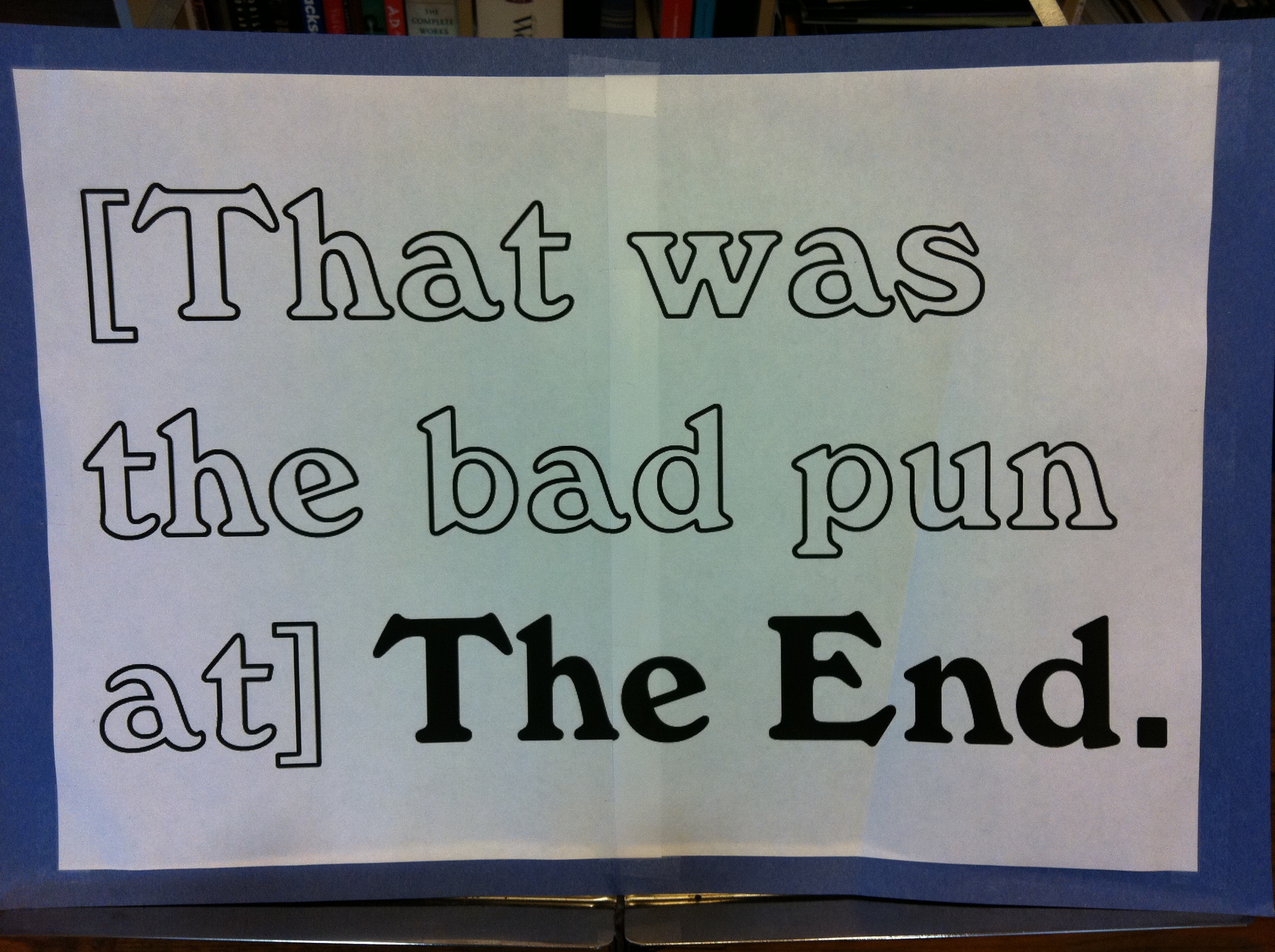A sign mounted on blue construction paper reads: "[That was the bad pun at] The End."