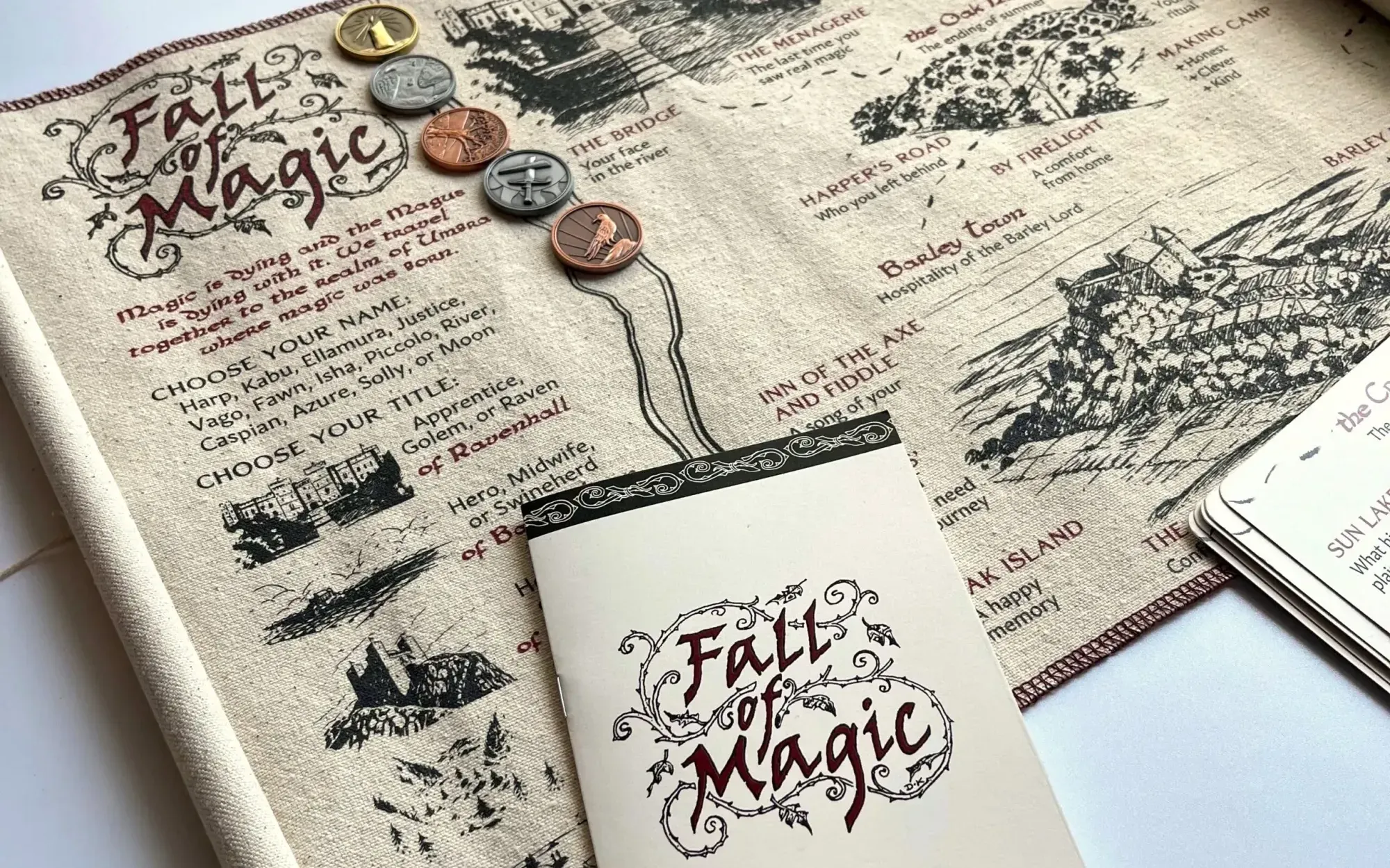 Fall of magic's map, rules, and coins laid on a table.