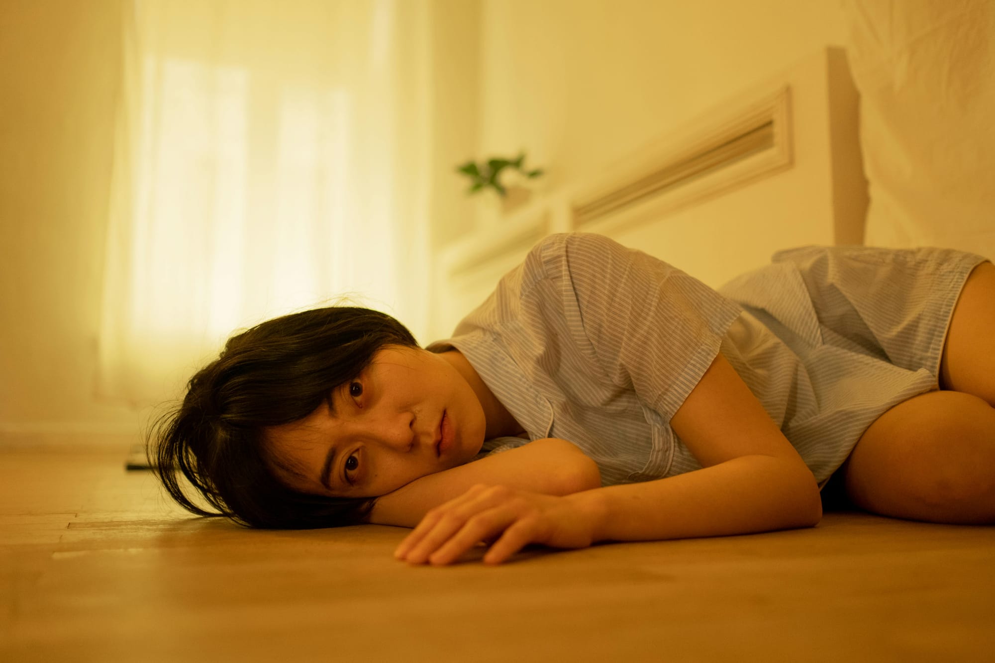 a-woman-in-pajamas-lying-on-the-floor