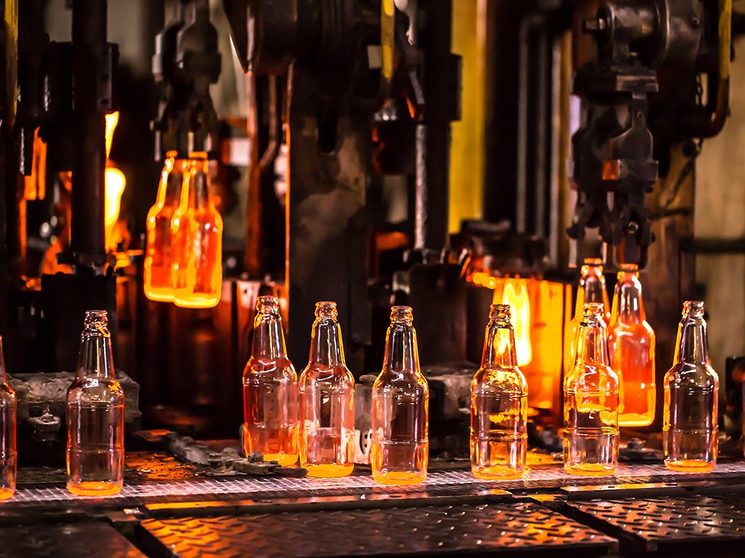 Glass bottles getting produced in a factory